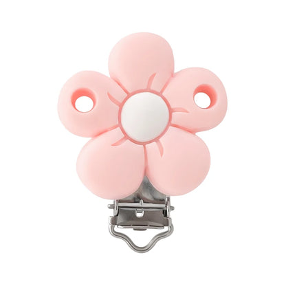 Clip attache-tétine en silicone en forme de fleur rose pastel avec centre blanc et mécanisme métal, pour création personnalisée.
